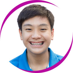 Young boy smiling wearing braces