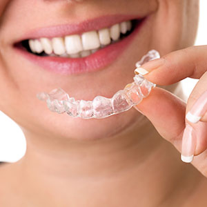 Lady using dental retainer